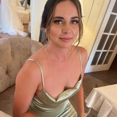Beauty by Krimse specializes in sleek low bun bridal hairstyles, Bridal hairstyle with a sleek low bun and a subtle veil.