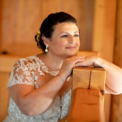 Capture timeless bridal elegance with Bride smiling gracefully in a traditional gown with soft makeup.