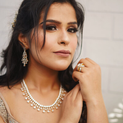 Beauty by Krimse creates classic bridal hairstyles with soft curls and elegant finishes, perfect for timeless wedding looks. Classic bridal hairstyle featuring soft curls and elegant styling.