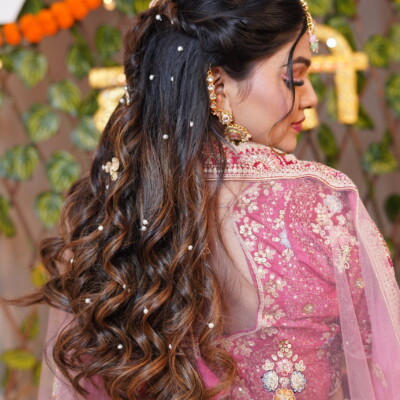 A traditional South Asian bridal hairstyle with intricate patterns, styled for weddings by Beauty by Krimse. Traditional South Asian bridal hairstyle with intricate details.