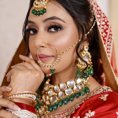 Beauty by Krimse enhances soft, dreamy bridal aesthetics Bride under soft lighting with a flowing veil and natural makeup.