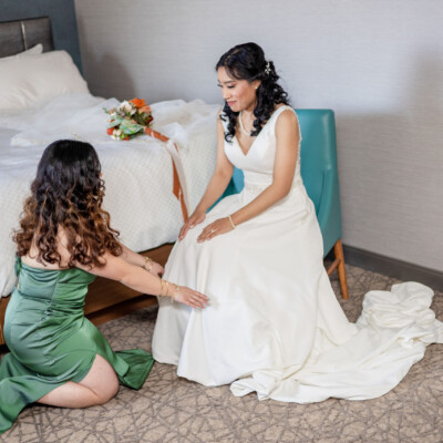 Beauty by Krimse delivers sophisticated bridal side buns, Bride posing in profile, showcasing an elegant side bun hairstyle.