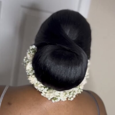 Beauty by Krimse's bridal hair and makeup services. Our expert touch enhances your natural beauty, helping you exude grace and elegance on your big day. Let us transform you into the most beautiful version of yourself for the nuptials. sleek bridal bun hairstyle