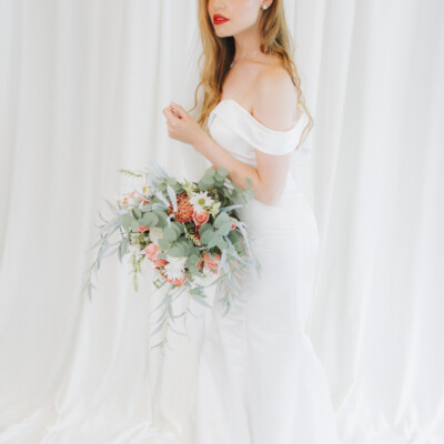 Let your bridal beauty shine with professional styling Bride sitting gracefully in an elegantly decorated venue.