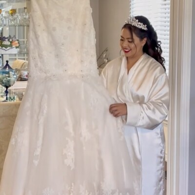 Beauty by Krimse’s romantic bridal hairstyles add soft Romantic bridal look featuring soft curls and a delicate floral accessory.