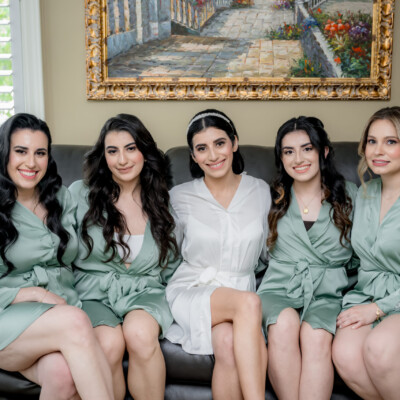 Beauty by Krimse creates understated elegance Bride in a soft natural makeup look, posing gracefully.